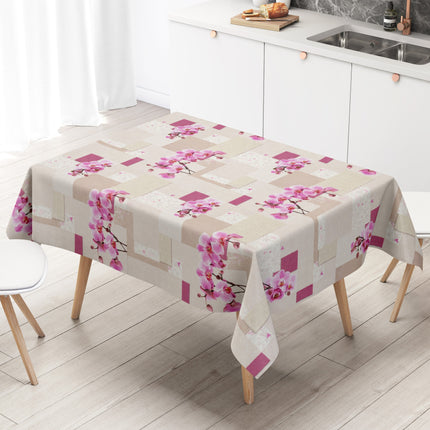 Rechteckiges Wachstuch mit hellem Beige- und Cremeton als Hintergrund, dekoriert mit großen rosa Orchideenblüten, pinkfarbenen Akzenten und einem modernen Patchwork-Muster aus Quadraten, Rechtecken und dezenten floralen Ornamenten. Die Tischdecke wirkt freundlich, elegant und romantisch.