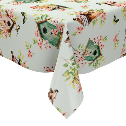 Wachstuch-Tischdecke mit Vogelhäuschen, kleinen Vögeln, Schmetterlingen und rosa Blüten auf hellem mintfarbenem Hintergrund. Grüne Blätter und natürliche Holztöne verleihen dem verspielten Frühlingsdesign eine frische, freundliche Ausstrahlung.